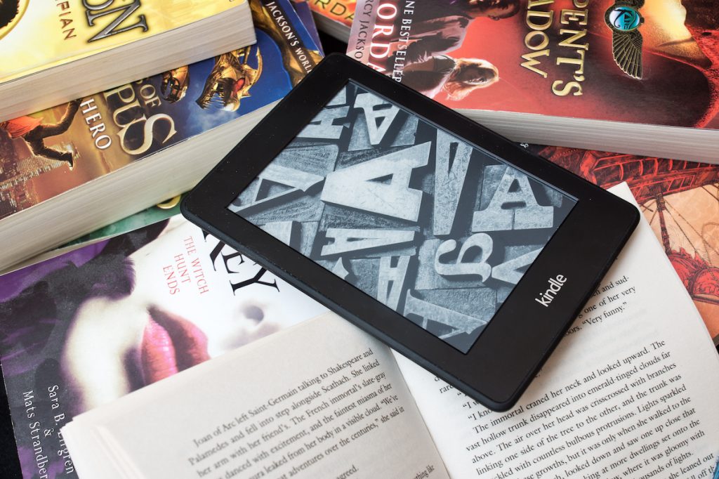 Amazon Kindle e book reader on the pile of books