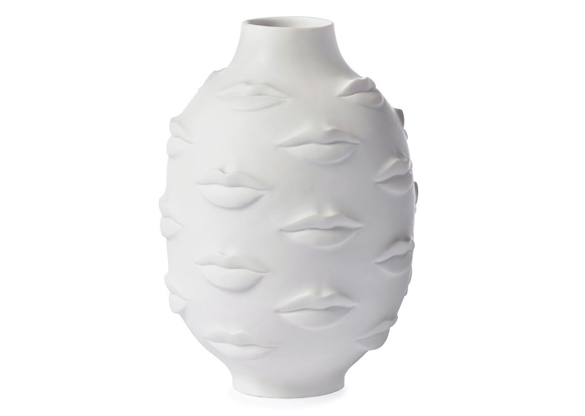 white ceramic vase with lips on it