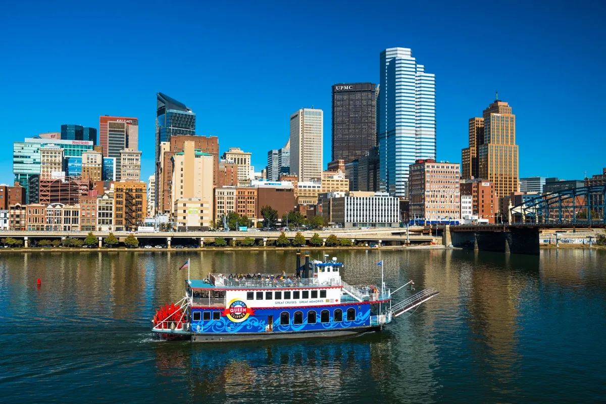 city skyline of and boar crossing river in Pittsburgh, Pennsylvania