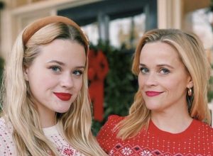 reese witherspoon and ava phillippe pose in matching draper james holiday sweaters