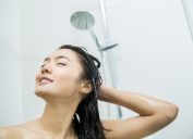 woman smiling while taking shower