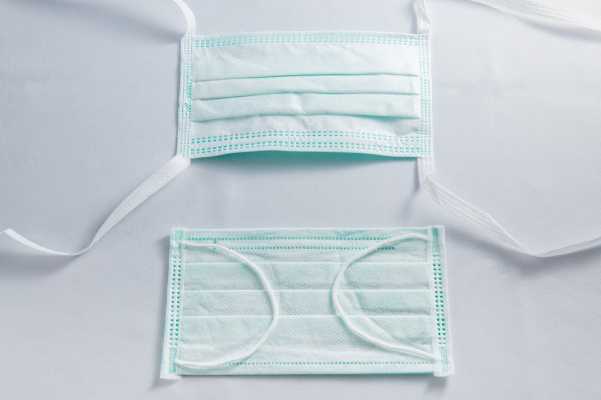 two blue surgical masks with ties for ear loops