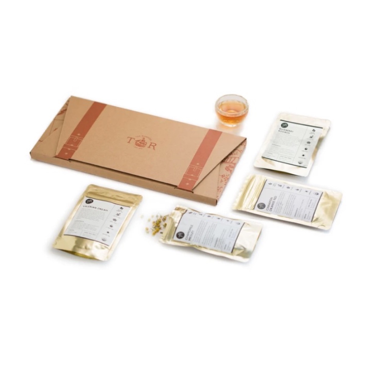 brown envelope and silver packets of tea