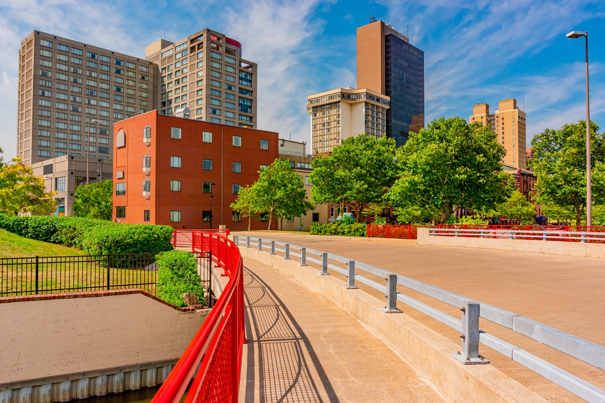 bridge with a bright red railing and buildings in downtown Toledo, Ohio