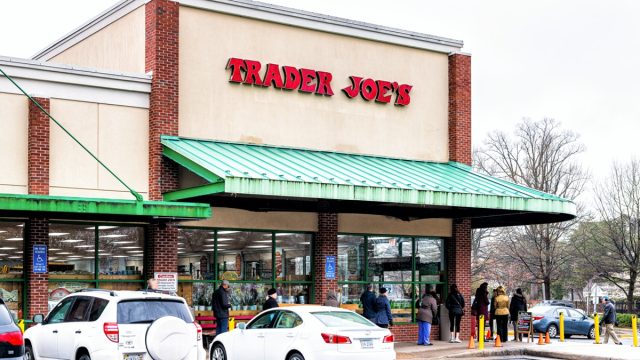 people lined up outside a trader joe's store