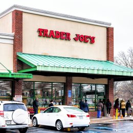 people lined up outside a trader joe's store