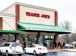 people lined up outside a trader joe's store