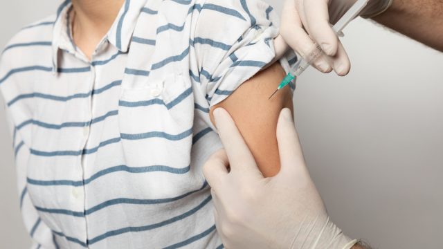 Young woman receiving coronavirus vaccine