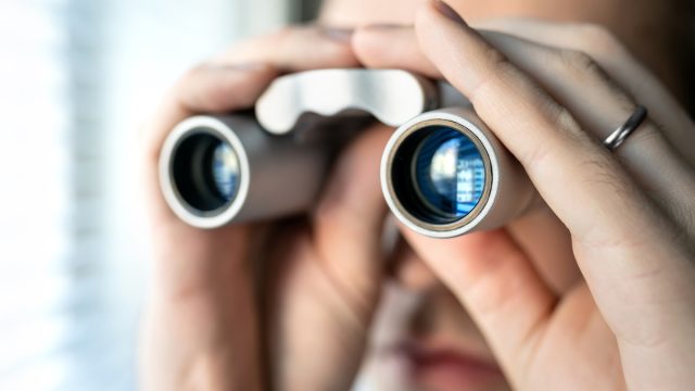 Jealous spouse using binoculars