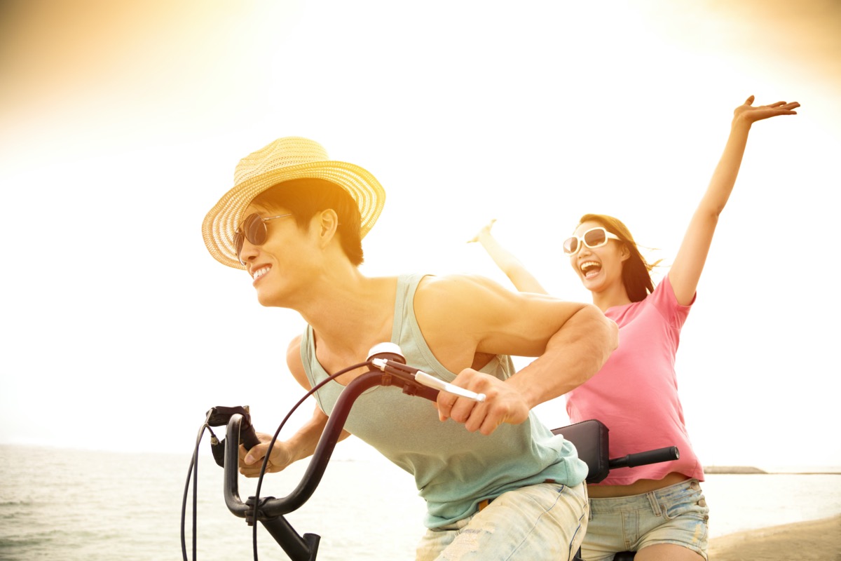 Man and woman riding tandem bike