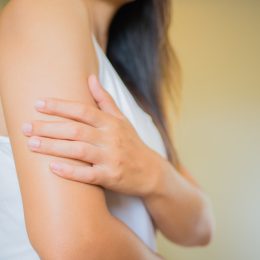 Woman examining arm