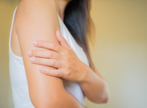 Woman examining arm