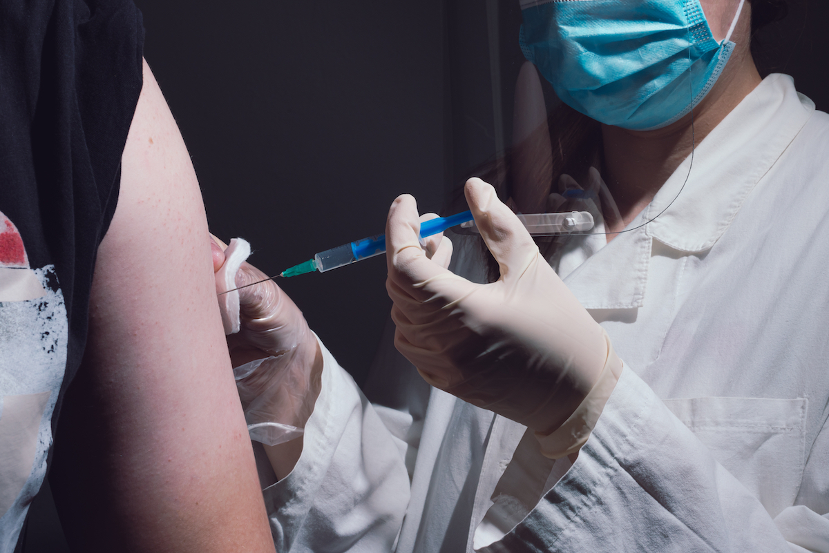 Person getting covid-19 vaccine close up