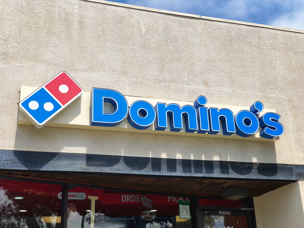 The front of a Domino's restaurant and franchise sign in Berkeley, California