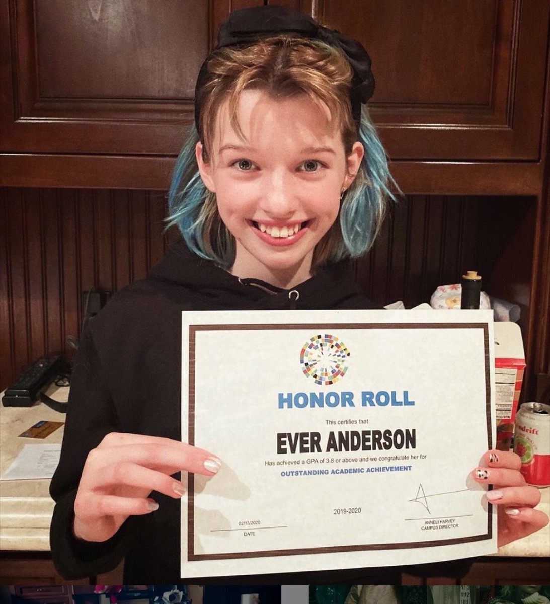 ever anderson holding up honor roll certificate