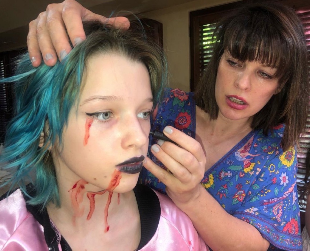 milla jovovich putting makeup on her daughter