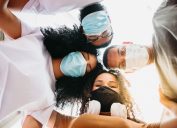millenial friends taking selfie smiling behind face masks