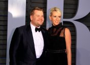 james corden and his wife julia carey on the red carpet in a black suit and dress, respectively