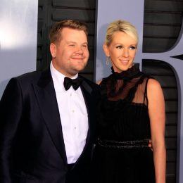 james corden and his wife julia carey on the red carpet in a black suit and dress, respectively