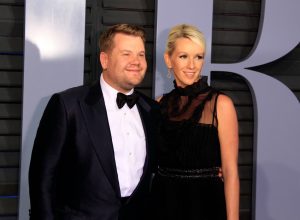 james corden and his wife julia carey on the red carpet in a black suit and dress, respectively