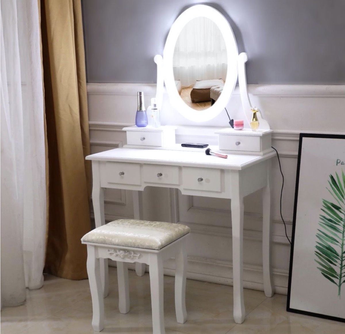 white vanity with oval mirror and LED lights