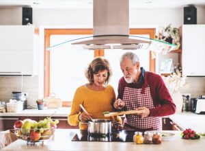 older couple preparing food together