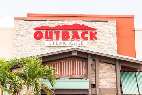 the entrance and sign of an Outback Steakhouse restaurant in Key West, Florida
