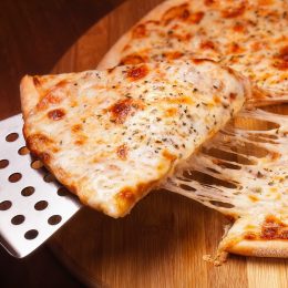 cheese pizza on a metal spatula