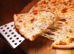 cheese pizza on a metal spatula