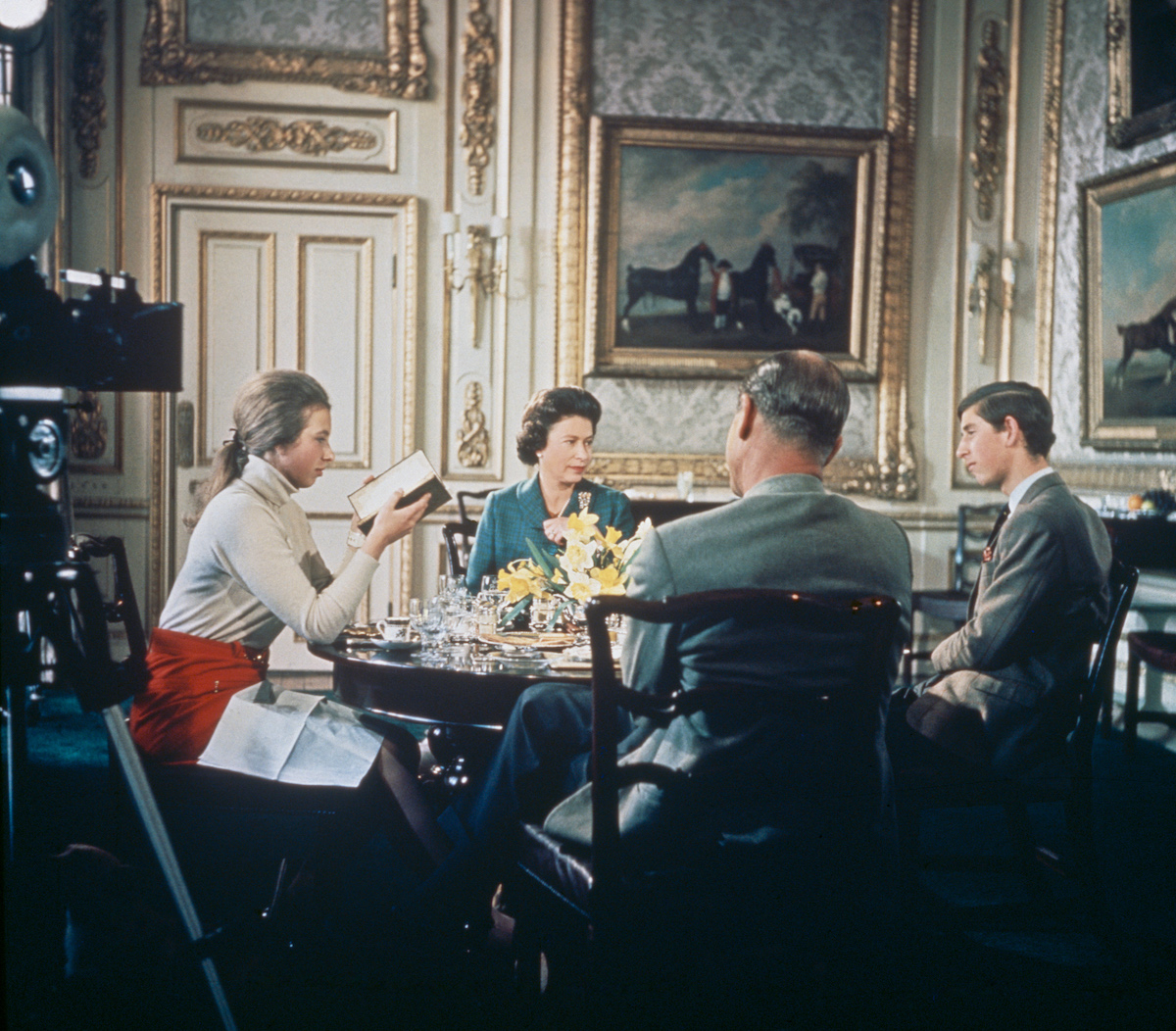 Queen Elizabeth II lunches with Prince Philip and their children Princess Anne and Prince Charles at Windsor Castle in Berkshire, circa 1969. A camera (left) is set up to film for Richard Cawston's BBC documentary 'Royal Family', which followed the Royal Family over a period of a year and was broadcast on 21st June 1969. 