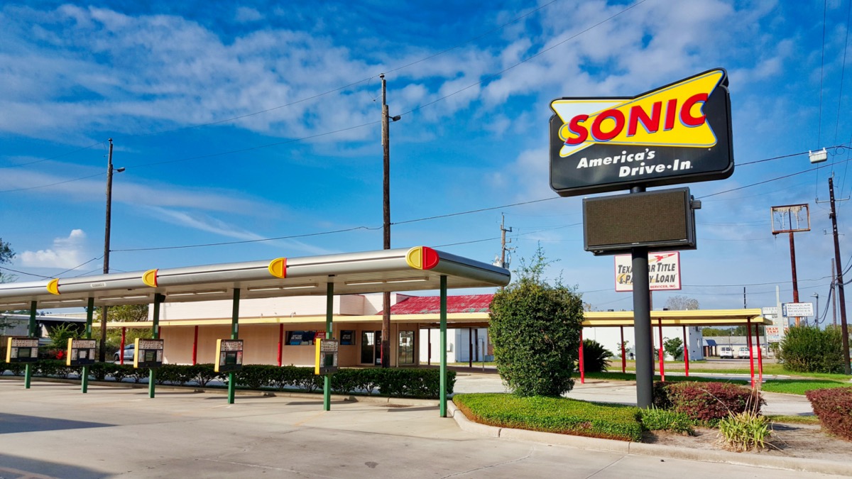 a sign and carhop spaces for Sonic Drive-In restaurant in Houston, Texas