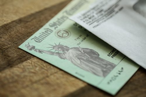 Extreme close-up of Federal coronavirus stimulus check provided to Americans from the United States Treasury in 2020, showing the statue of liberty.