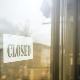 glass door with store closed sign