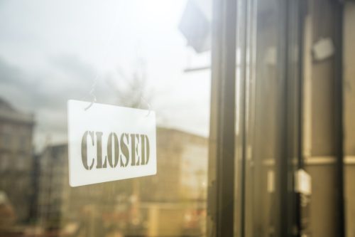 glass door with store closed sign