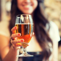 young woman holding a glass of beer