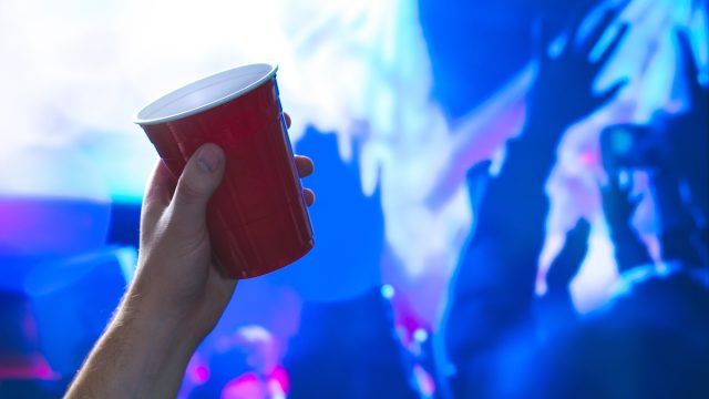Hand holding a red solo cup at a party