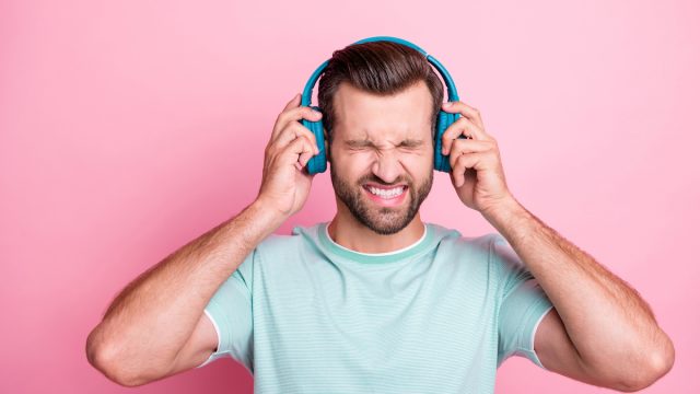 Man with headphones listening to bad music