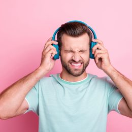 Man with headphones listening to bad music