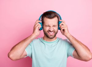 Man with headphones listening to bad music