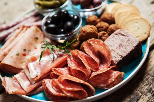 charcuterie plate with meats and black olives