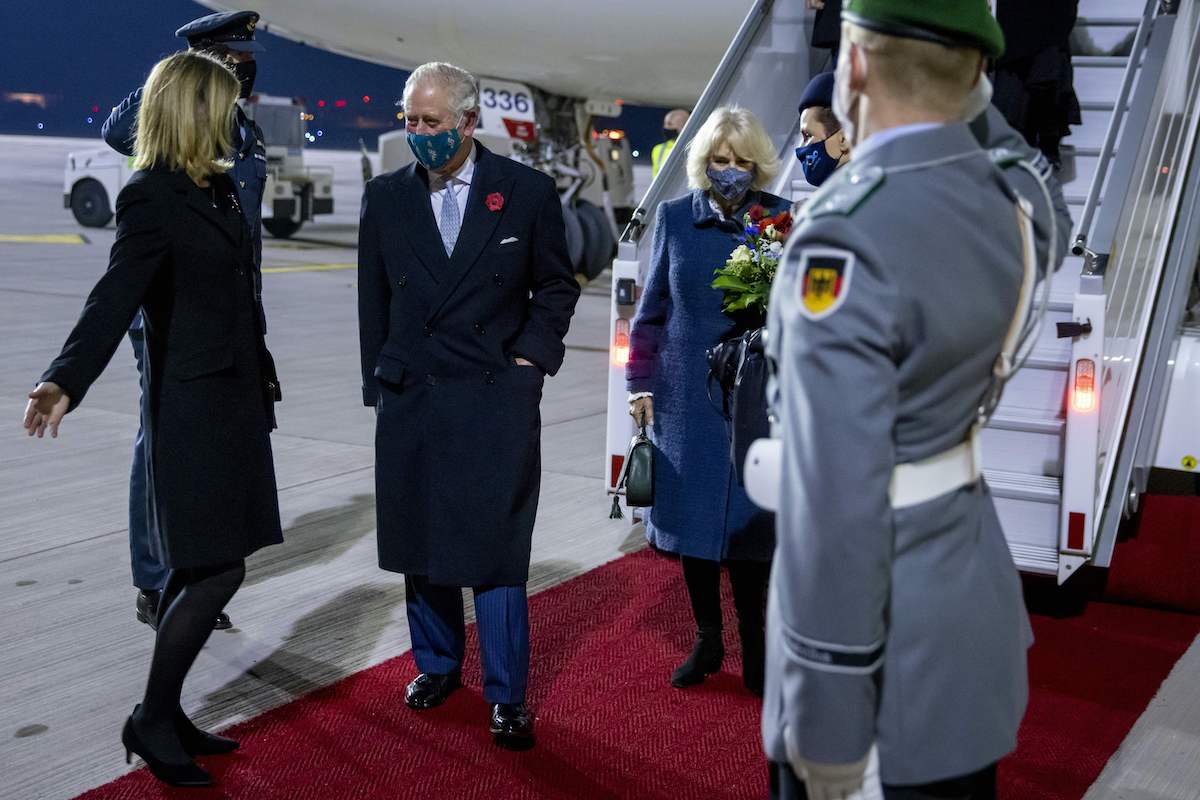 Britain's Prince Charles walks with the British ambassador to Germany Jill Gallard arriving at Berlin Brandenburg Airport (BER) in Schoenefeld on November 14, 2020.