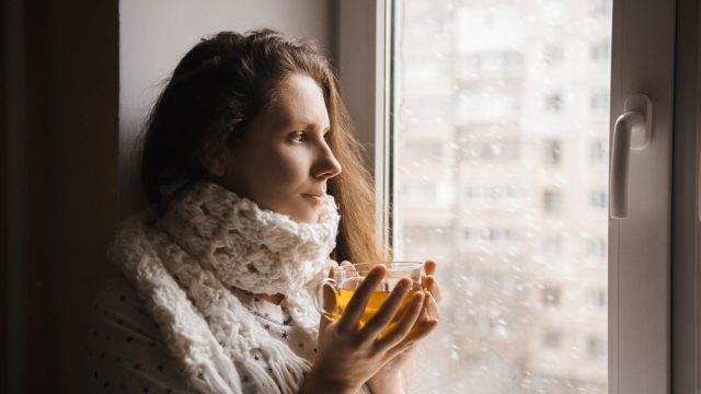 cold woman drinking a cup of tea
