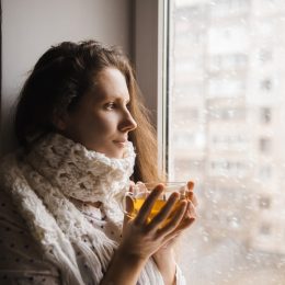 cold woman drinking a cup of tea