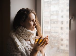 cold woman drinking a cup of tea