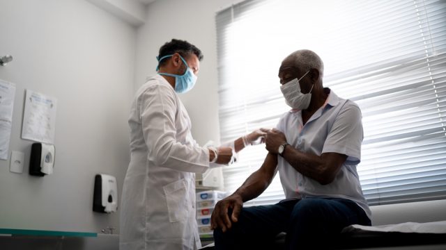 Nurse applying vaccine on patient's arm