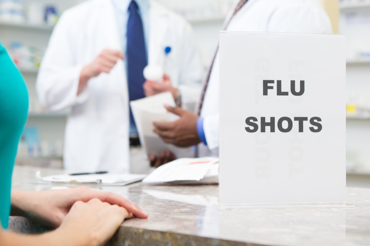 Sign in neighborhood pharmacy advertising "Flu Shots" vaccinations