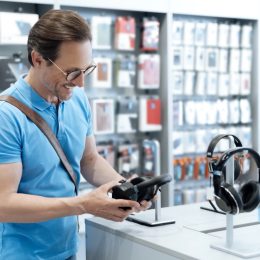 Man shopping for headphones at electronics store