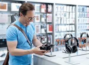 Man shopping for headphones at electronics store