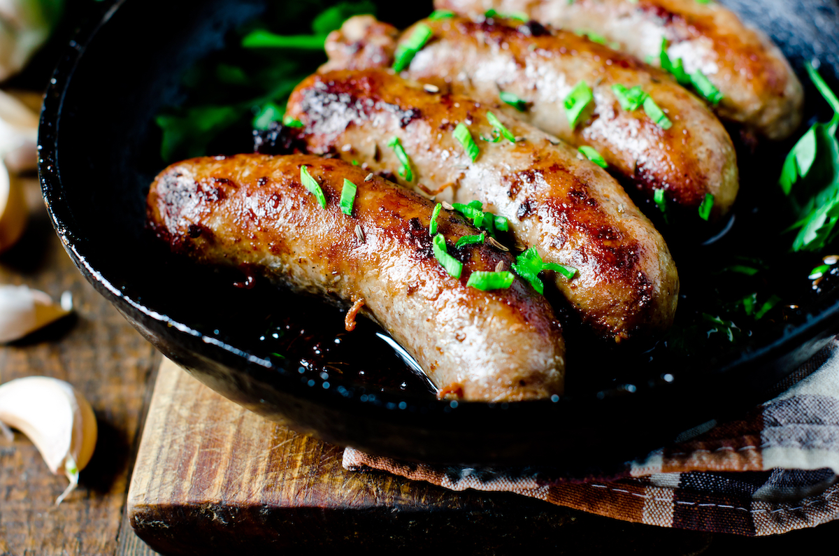 Sausages fried in a frying pan