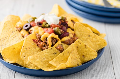 Beef nachos with jalapeno, olives, tomato, beans cheddar cheese and sour cream